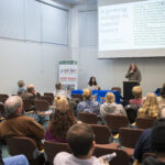 people listen to student making presentation