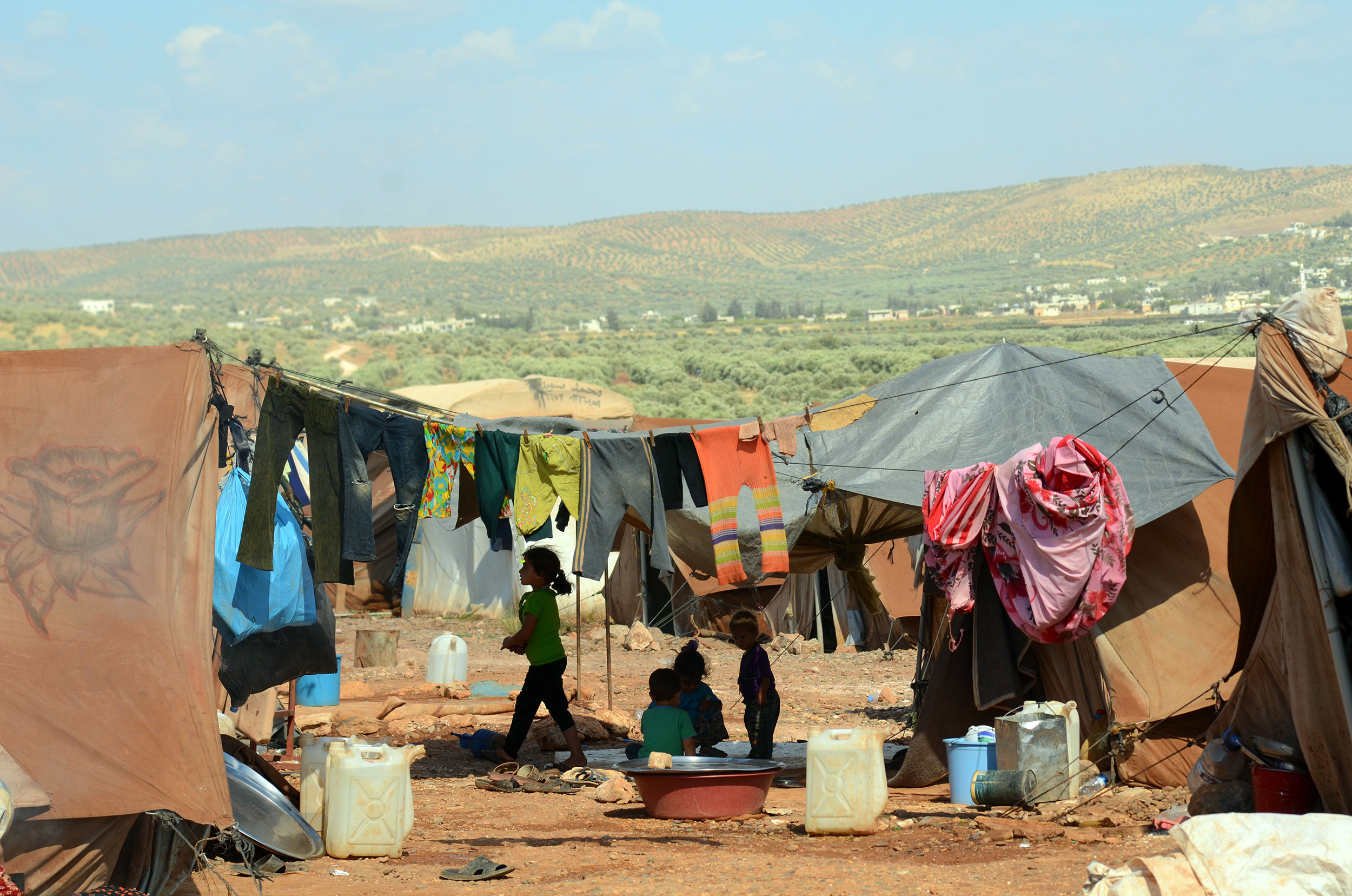 Tents and children in a refugee camp in Ahmeh, Syria
