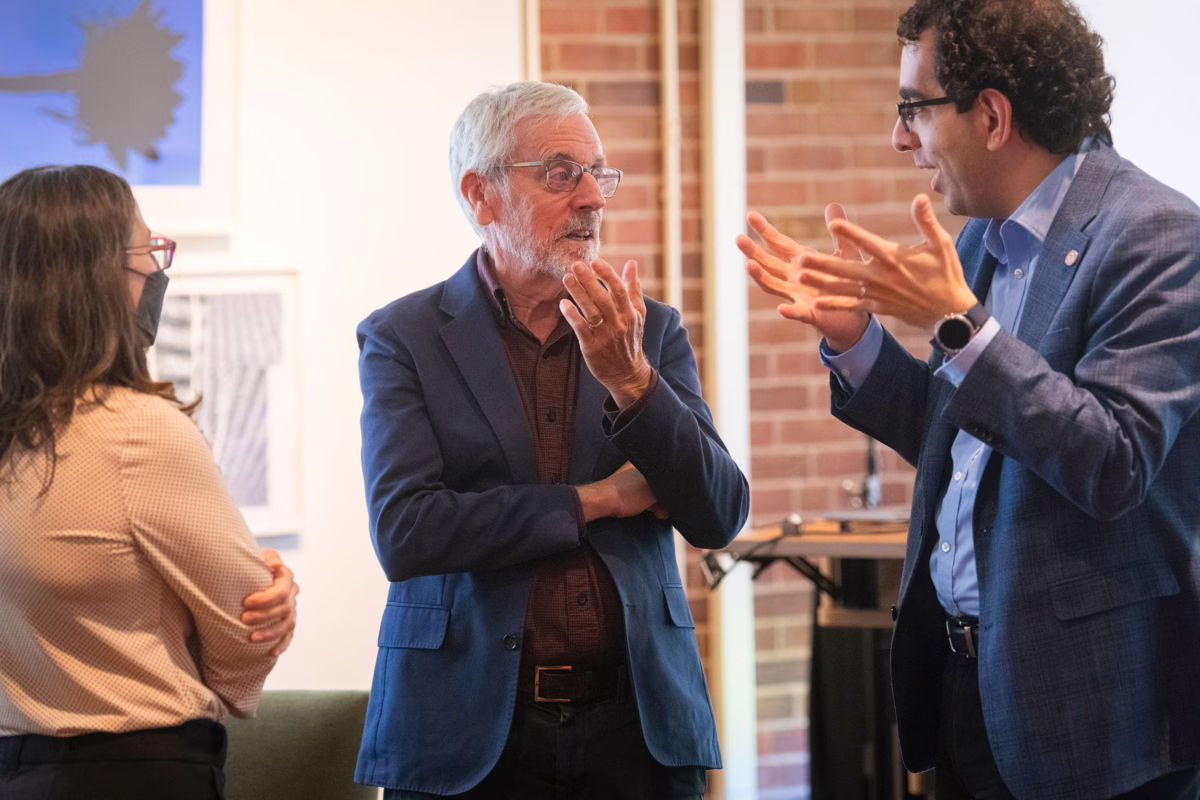From left, Florencia Sangermano, Allen Carroll, and Hamed Alemohammad discuss mapmaking