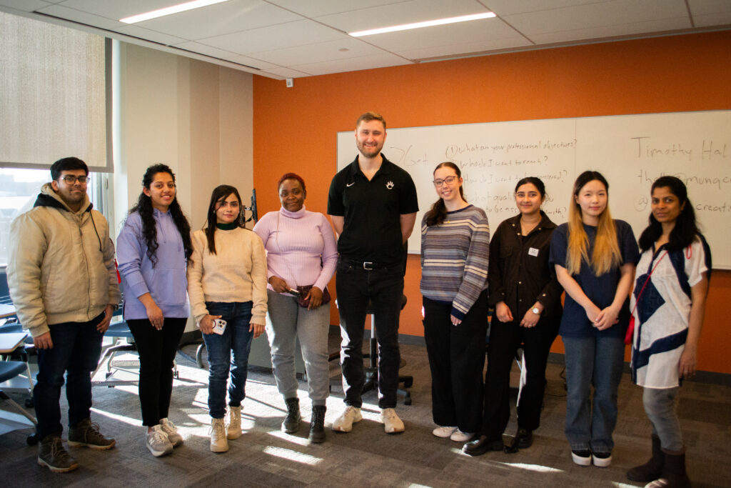 professor poses for photo with students