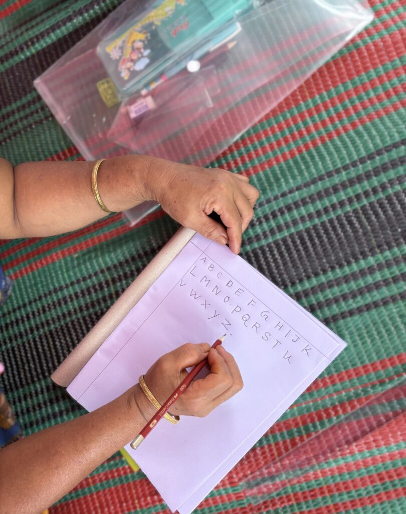 person write alphabet on paper