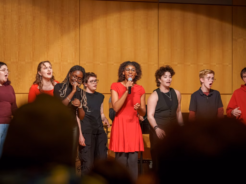 performing arts show with people singing on stage