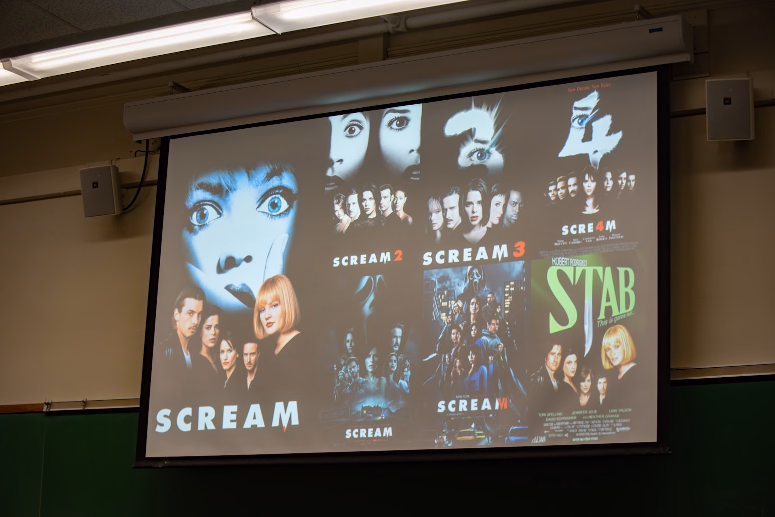 horror movie posters projected on screen