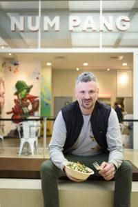 Ben Daitz eating salad sittng outside