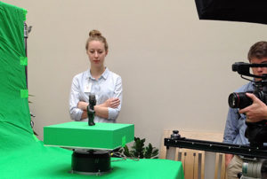 Elisabeth Spak '16 considers the pre-Columbian Olmec Incised Standing Figure at a video shoot.
