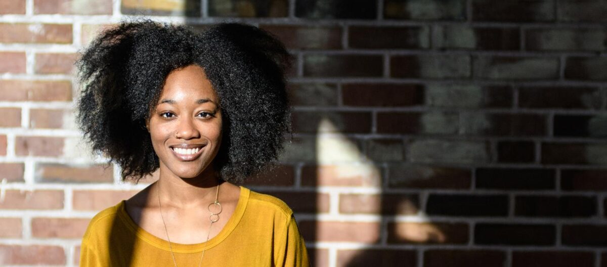 Daysha Williams standing in front of brick wall