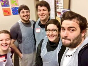 Pictured from left to right: Ali Gillard '18, Ben Gardner '12 and Sam Kennedy '18, pose with site leaders from Break a Difference at a food bank in NYC.