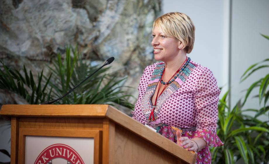 Lady giving a speech during reunion dinner