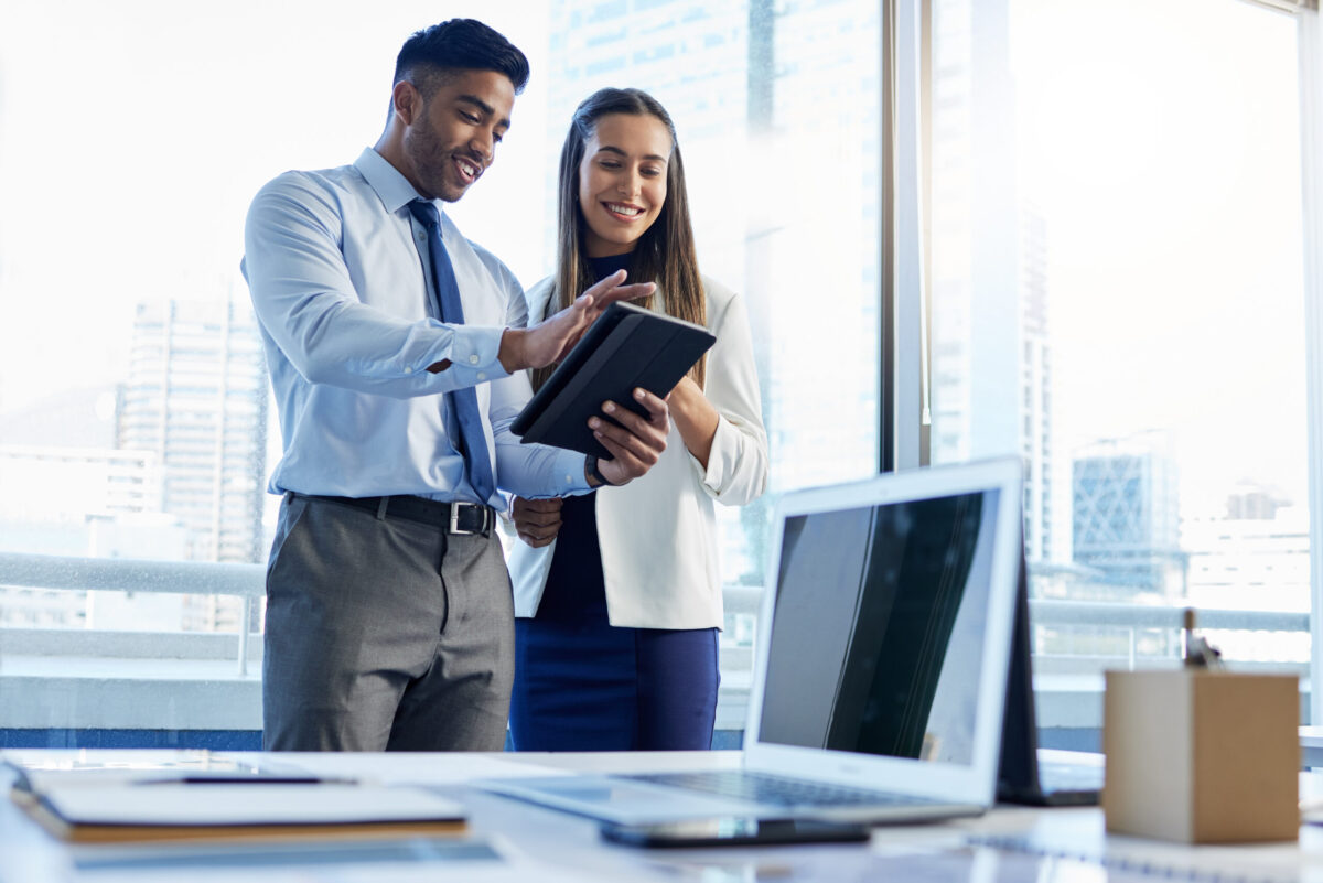 two people standing at desk