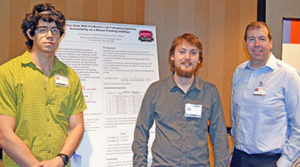 student and professor standing in front of poster