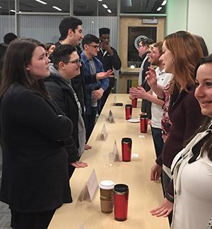 students standing on both sides of a table