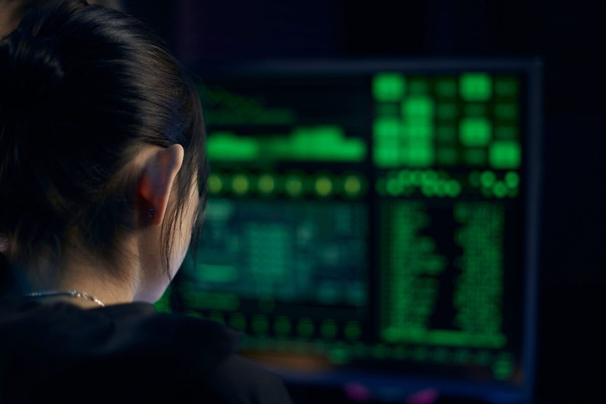 young woman looking at code on computer screen
