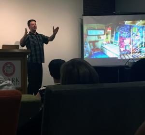 Diedricksen shows images of his building projects during a recent presentation at Clark.