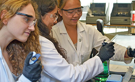 From left, Lara Prosterman '17, Emilie Ogisu '17 and Pinky Htun '17 purify proteins in the laboratory. Their work in the lab last summer was sponsored via Clark's Interdisciplinary Summer Research Program; they have continued to work in the lab this year.