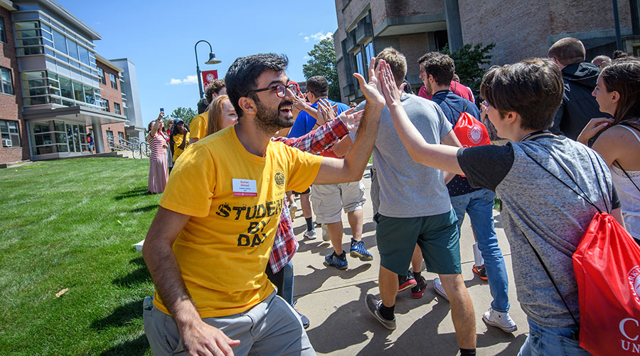 students giving high-five