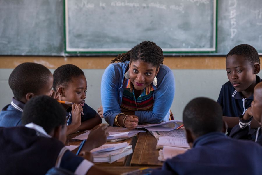 teacher in classroom working with oys