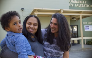Professor Laurie Ross helps a new mother