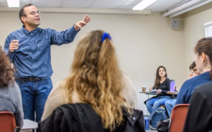Spanish professor talking to professor students in classroom