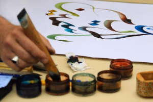 A calligraphy artist working on an artwork. iStock