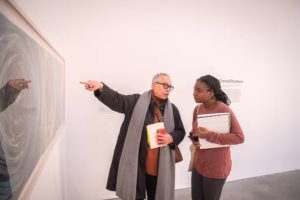 Visual and performing arts professor Toby Sisson points out a detail to a student during a visit to the ICA, Boston