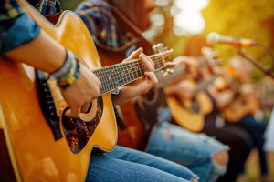 community music - Musicians play guitars during a live performance at a cozy outdoor festival