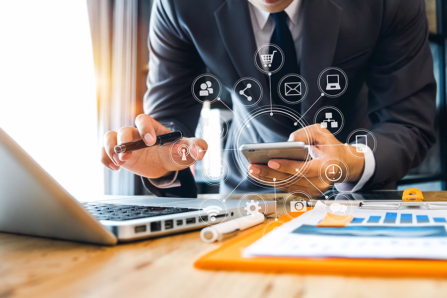 man with laptop and phone