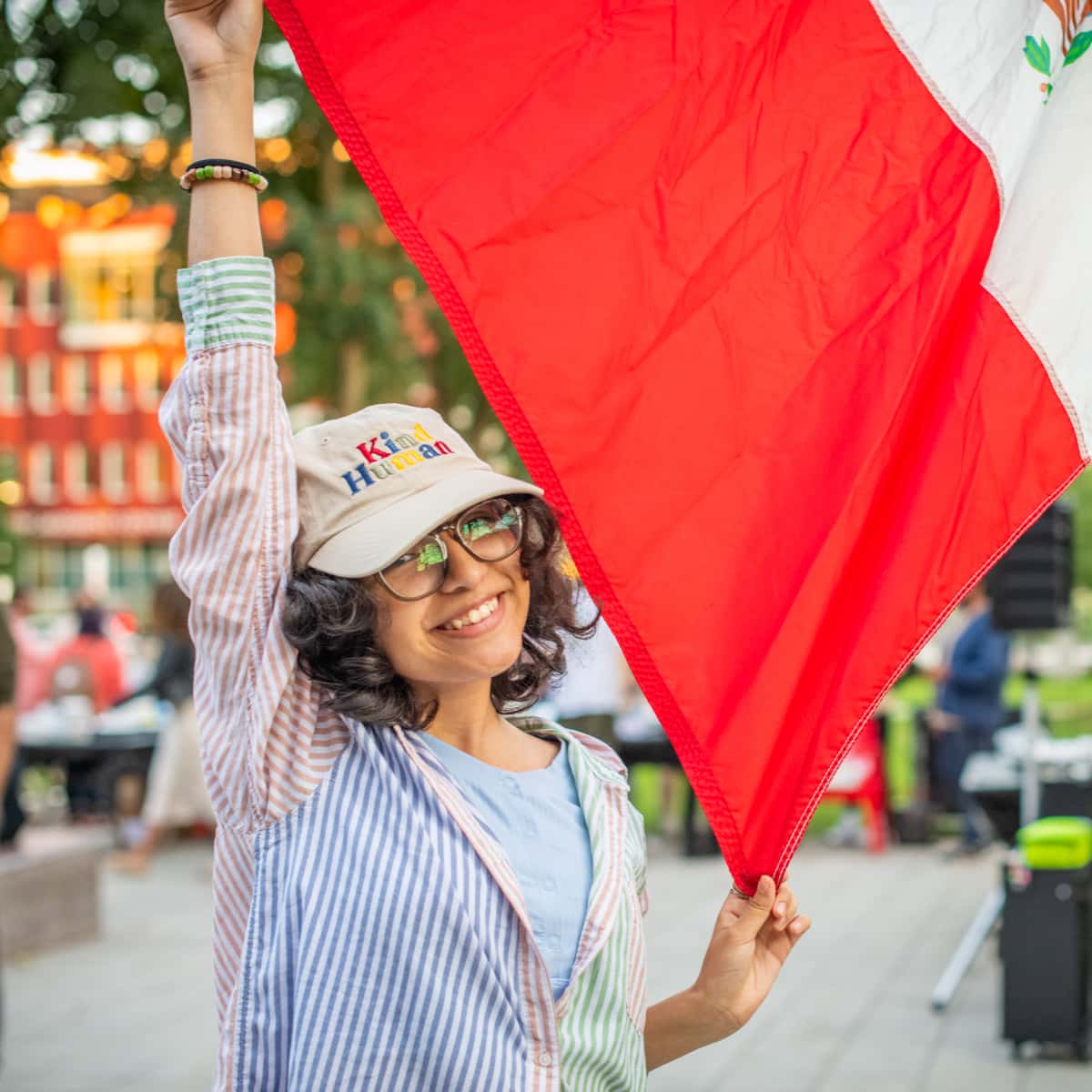 A student holds up the flag of Mexico