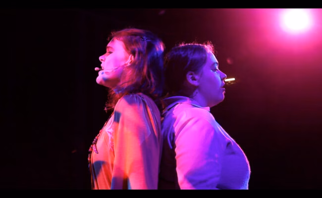 Theatre Arts students performing on stage singing