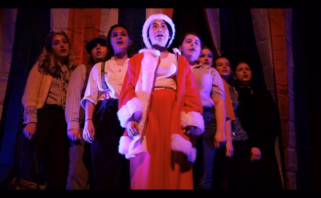 theatre arts students one dressed in santa claus