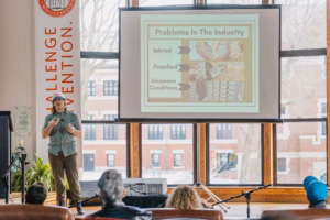 A student presenting their business plan at the Clark Tank pitch event