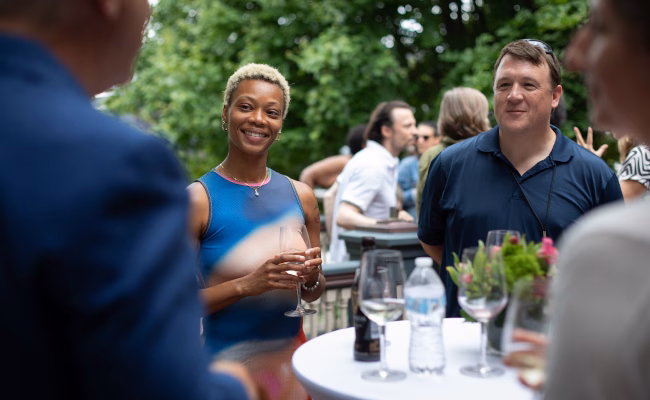 Group of people around table at art reception