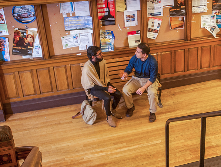 graduate student with professor sitting in hall