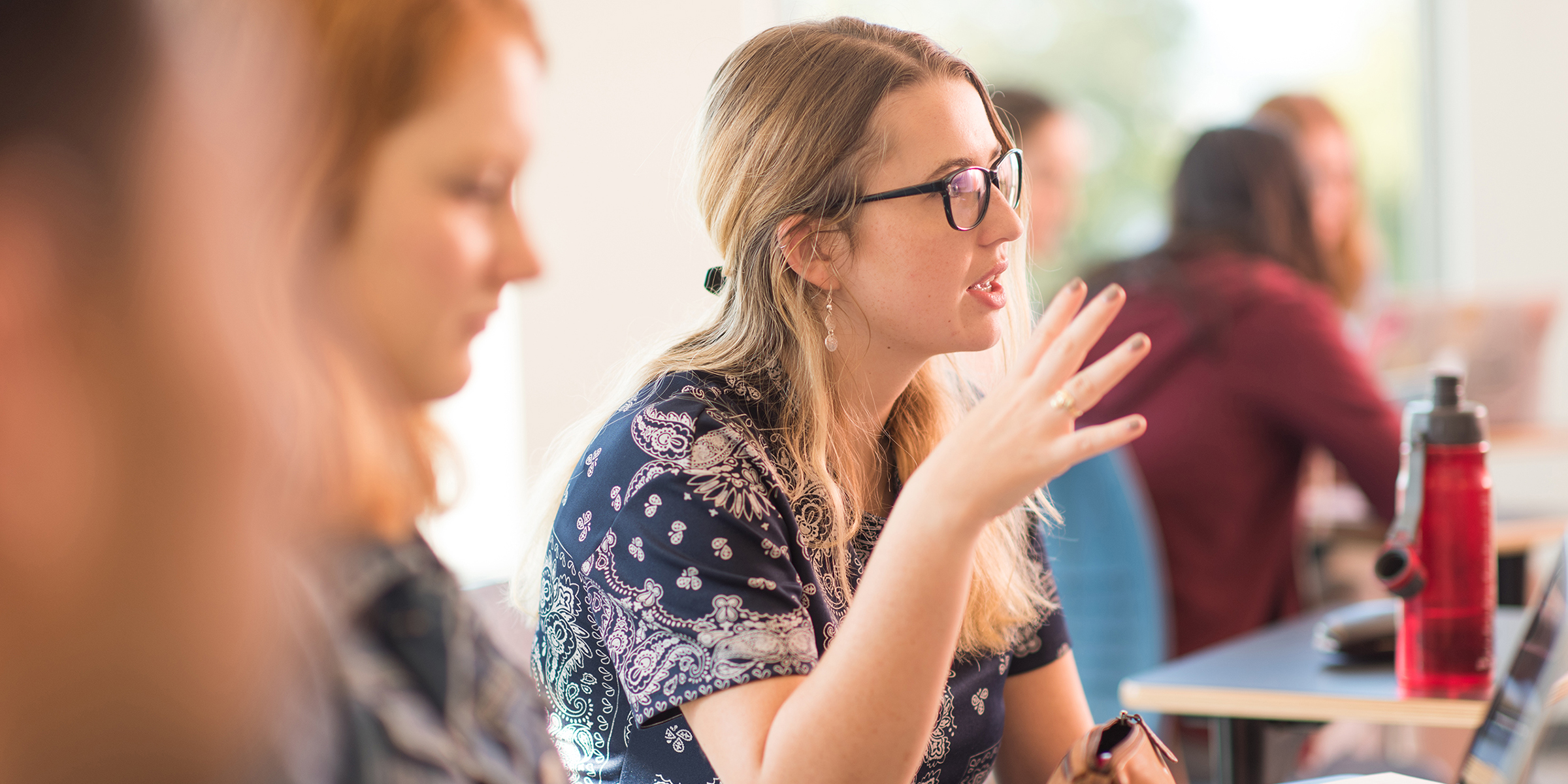 Psychology student gesturing and talking in classroom