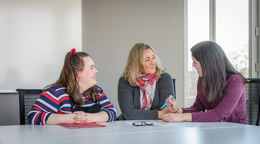 students talking to faculty members