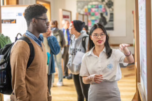 students showing poster boards at Clarkfest