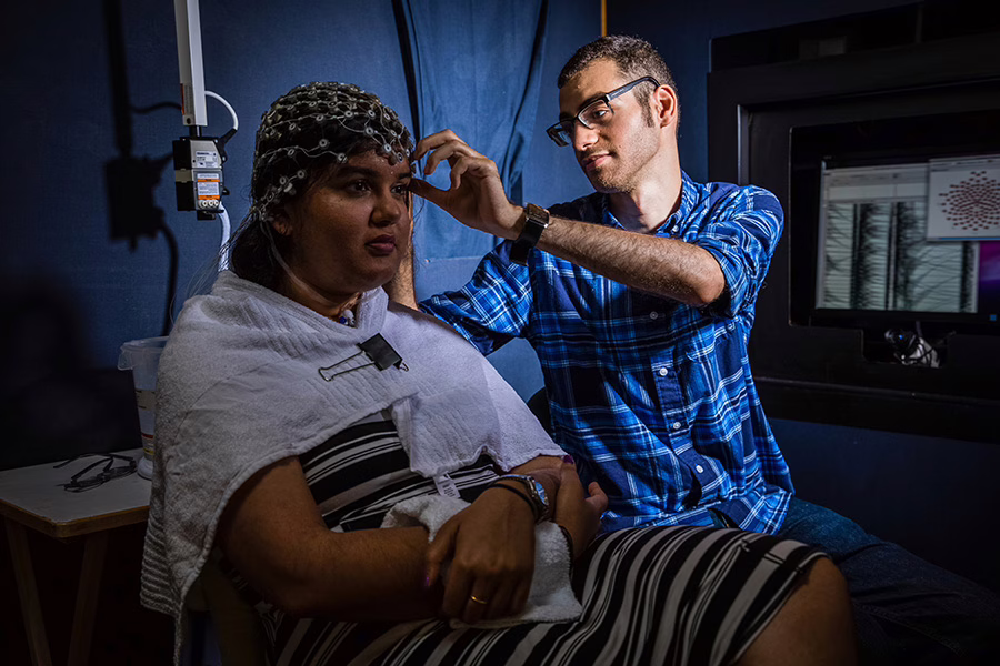 student putting head cap on subject