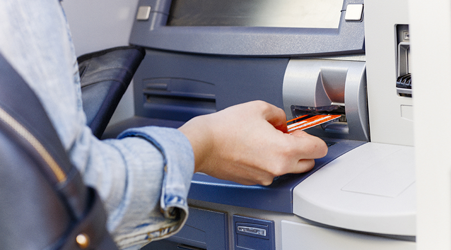 Hand inserting ATM credit card