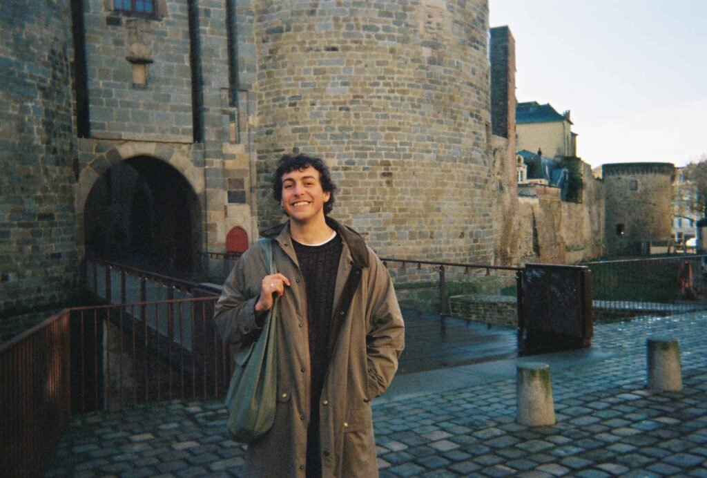 Jake Bernstein ’26 standing in front of a castle during his semester abroad in Rennes, France