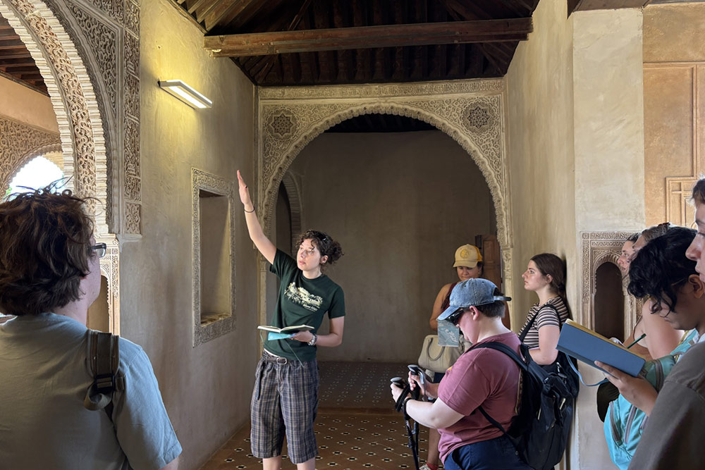 A student making a presentation at a historical site in Seville during the Leir program in Spain and Turkey