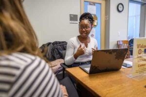 academic advisor with student at desk