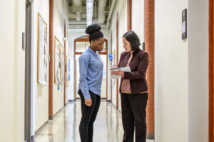 Faculty adviser with student