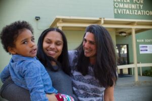 Professor Laurie Ross works with a local family at the Center for Community Revitalization