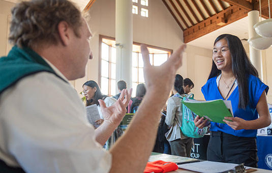 A student meets with a counselor during a career fair