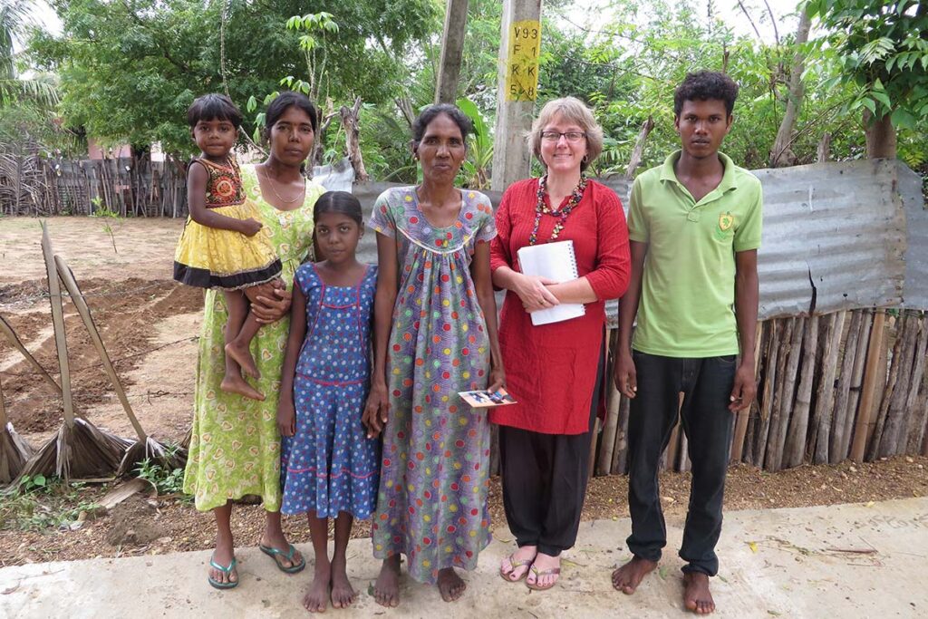 Professor Cindy Caron with a group of people during a research project.