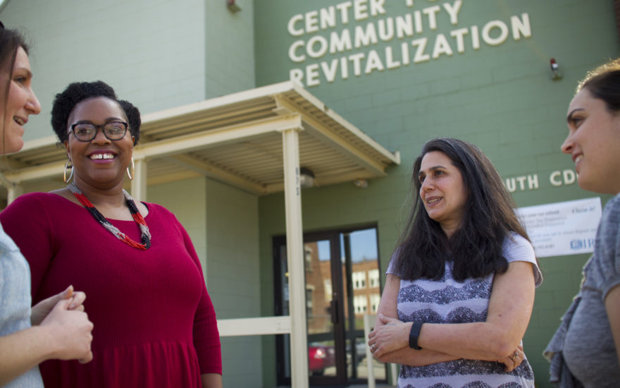 Laurie Ross talking to community leaders in front of community center.