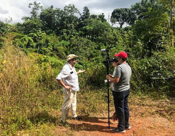 Ramón Borges-Méndez at work in Puerto Rico, next to a colleague with survey equipment