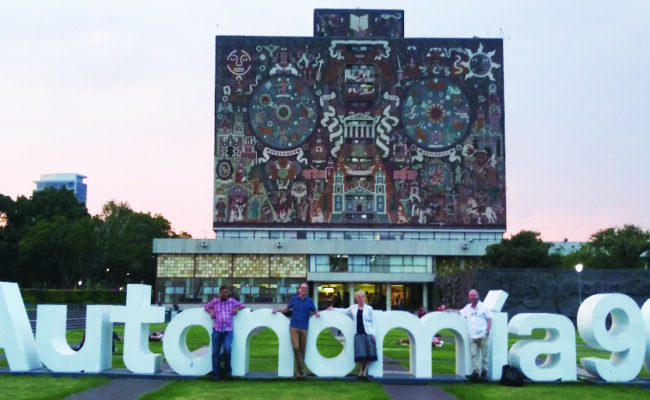 The Clark Team in front of the iconic mural-covered Central Library.