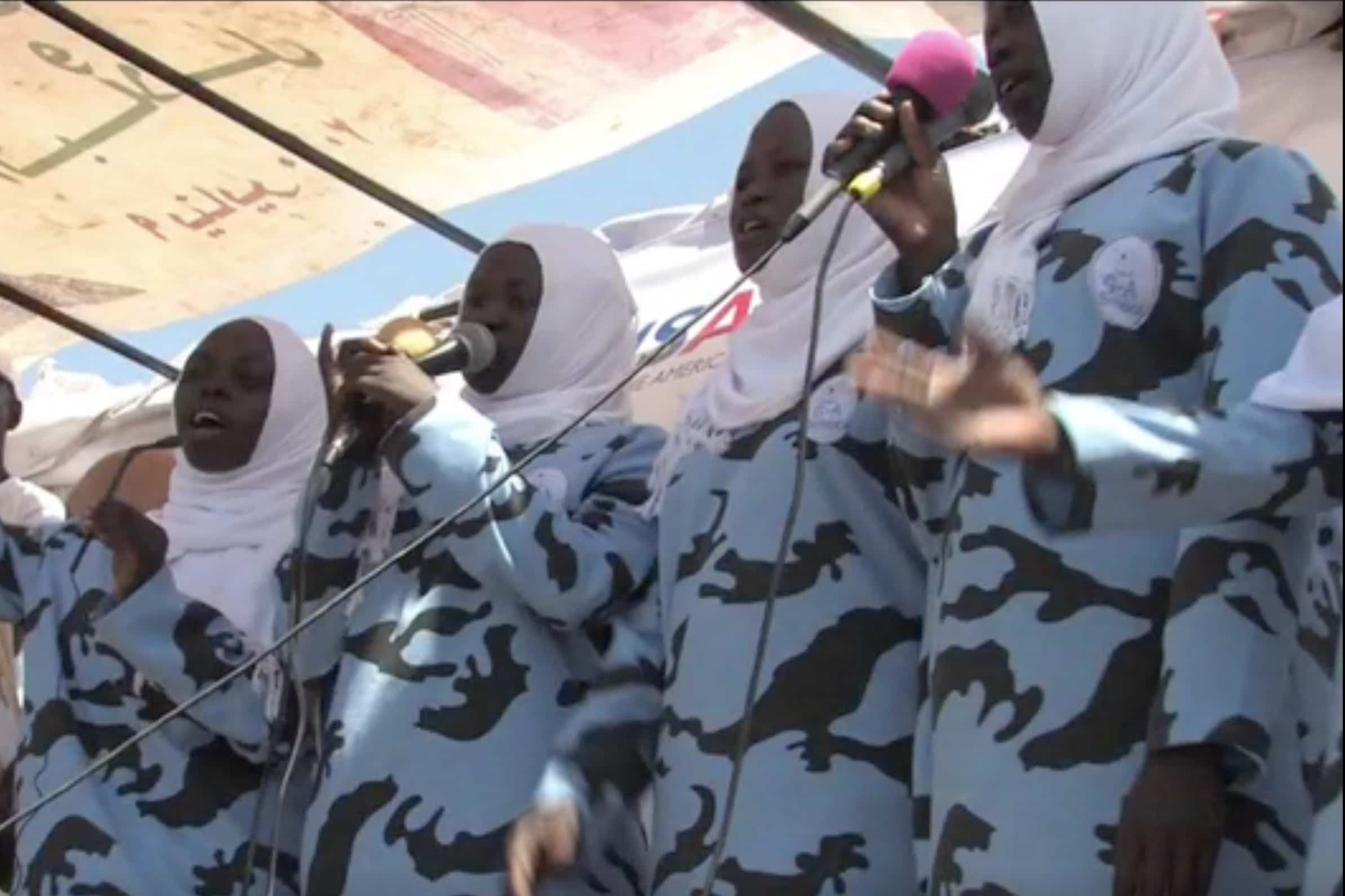 students sing during a ceremony at the school