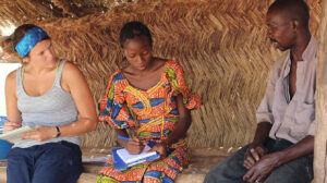 Two researchers interviewing local resident in Africa