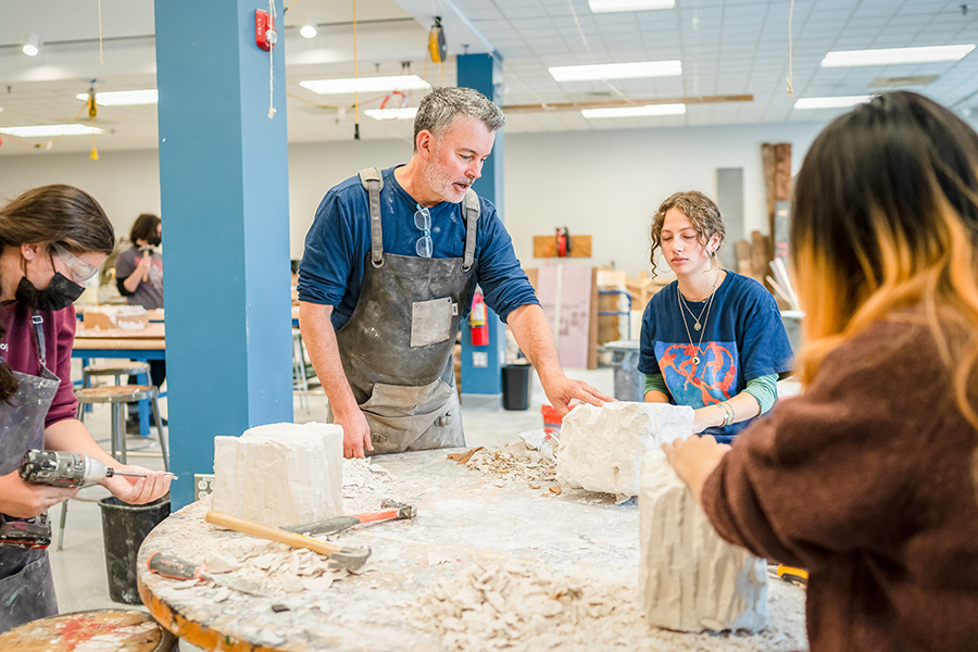 Professor with students in art class